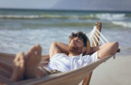 man relaxing in hammock