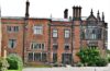 Red-brick exterior and tall chimneys of Arley Hall in Cheshire