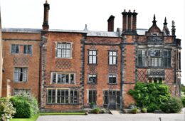 Red-brick exterior and tall chimneys of Arley Hall in Cheshire