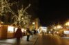 Christmas lights and stalls on Northgate Street in Chester at night.