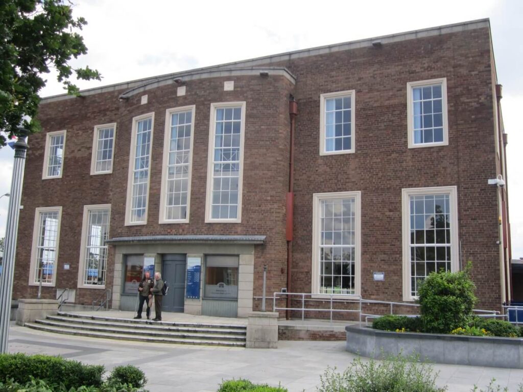 The brick frontage and entrance of Ellesmere Port Library.