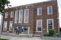 The brick frontage and entrance of Ellesmere Port Library.