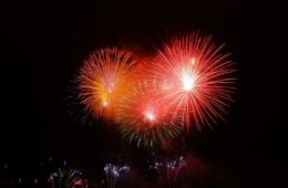 Red and orange fireworks against a dark sky