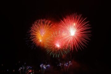 Red and orange fireworks against a dark sky