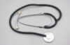 A black and silver stethoscope on a pale background.